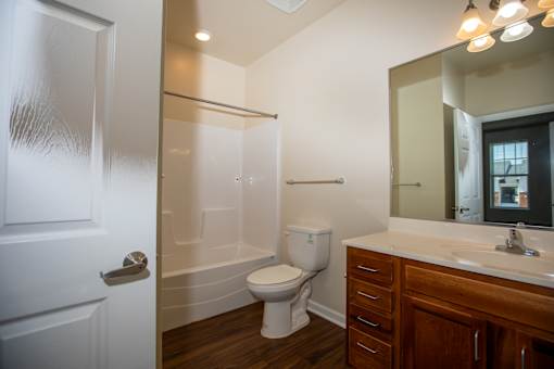 A bathroom with a toilet, sink, and shower.