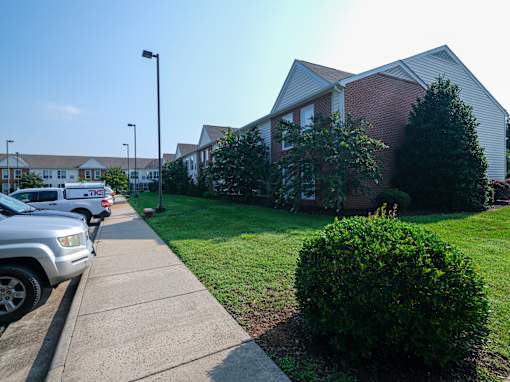 A residential area with houses and parked cars.