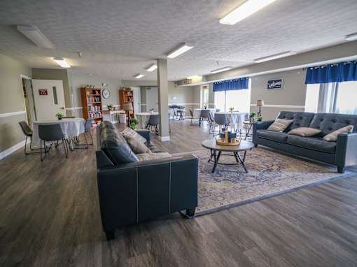 A living room with a grey couch and a coffee table.
