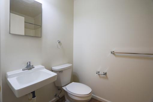 A white sink and toilet in a small bathroom.