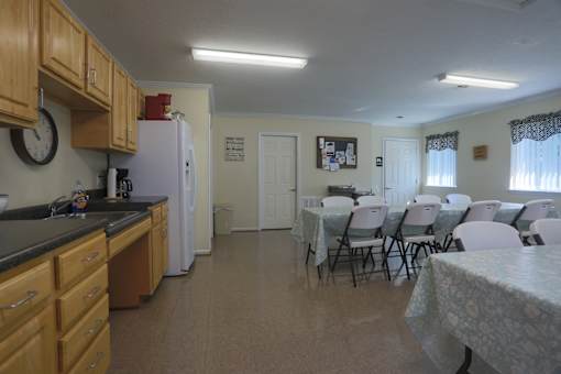 A kitchen with a table and chairs in the middle of the room.
