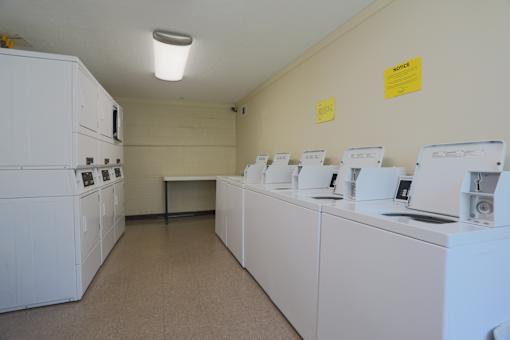 A laundry room with washers and dryers.