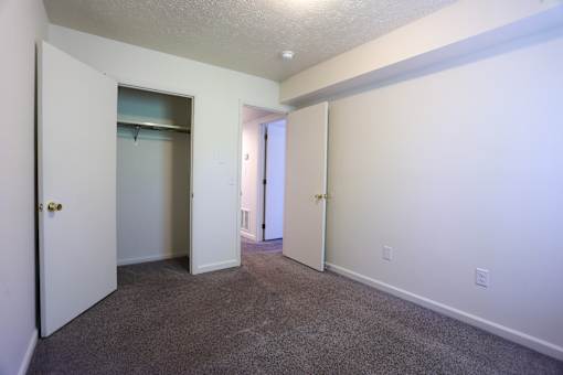A room with a carpeted floor and white walls.