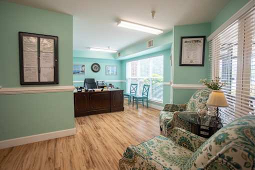 A room with green walls and a wooden floor.