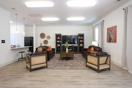 A living room with a couch, a chair, and a coffee table.