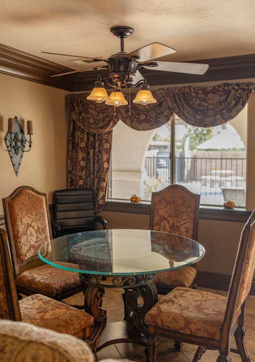 A dining room with a glass table and chairs.