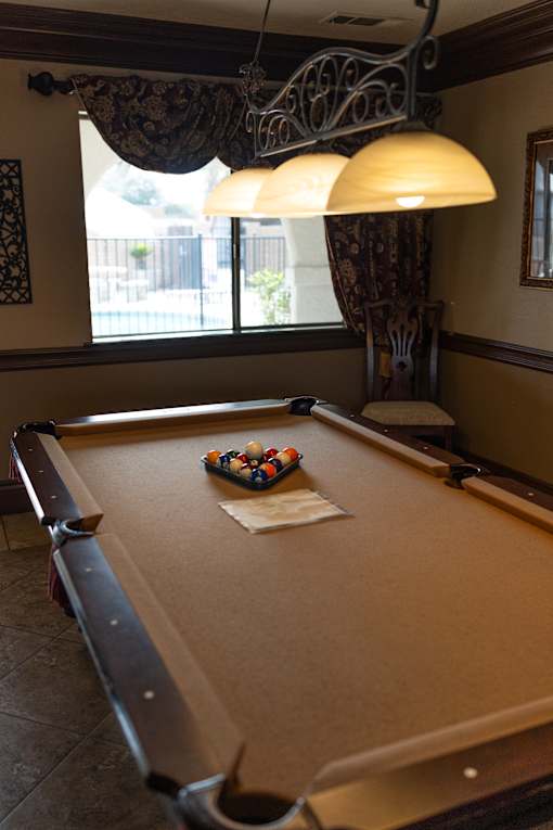 A pool table with a cloth and balls on it.
