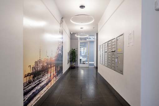 A long hallway with a mural of a ship on the wall.