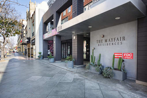 The Mayfair Residences is a modern building with a flat roof and a balcony.
