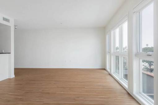 A room with wooden floors and white walls.