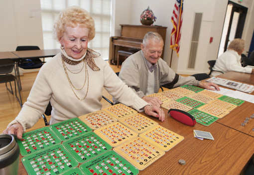 Two elderly people playing a board game.