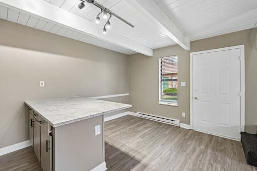 A kitchen area with a countertop and cabinets.