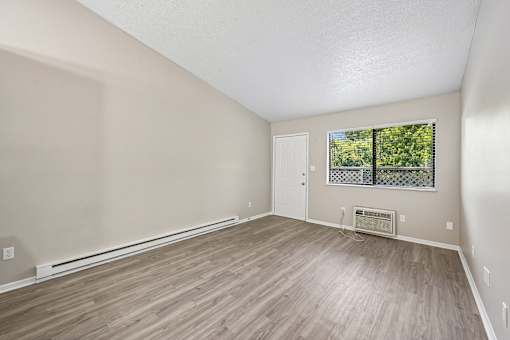 A room with light brown flooring and white walls.