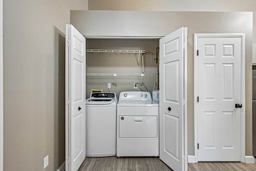 A small laundry room with a washer and dryer in it.