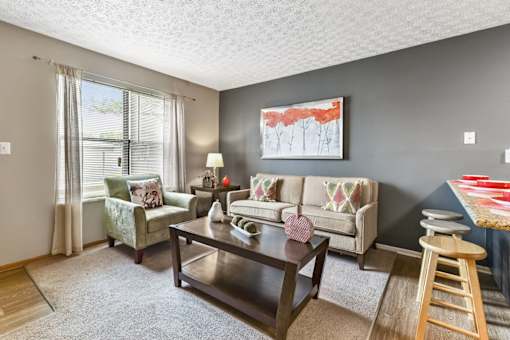 A living room with a couch, chair, and coffee table.