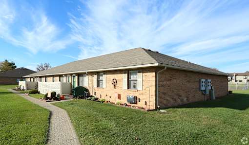A house with a brown brick exterior and a grey roof.