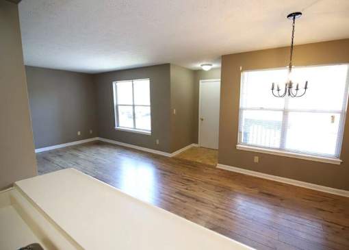 A room with a white table and a chandelier.