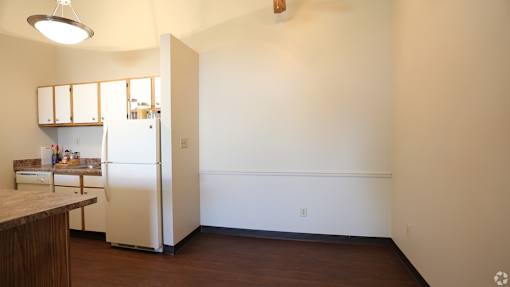 A kitchen with a refrigerator and a counter.