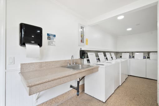 a kitchen with a sink and a counter and a washing machine