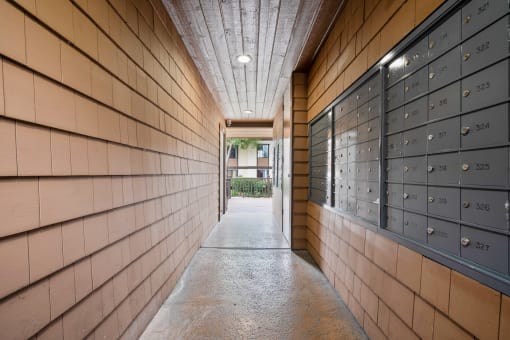 a long hallway with wooden walls and lockers with numbers on them