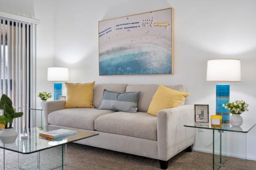 a living room with a couch and two tables