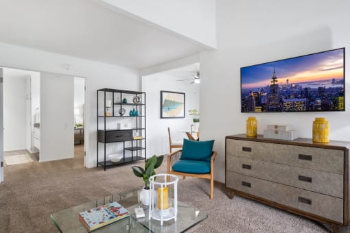 a living room with a couch and a table and a tv