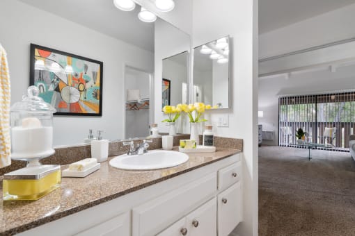a white bathroom with a sink and a mirror