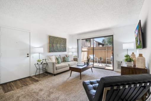 a living room with a couch and a sliding glass door