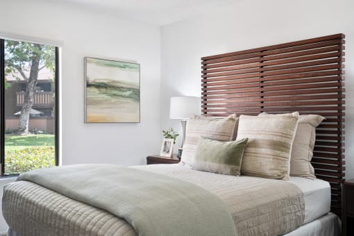 a bedroom with a bed and a large window