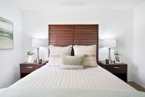 a bedroom with a bed and a pink and purple wall