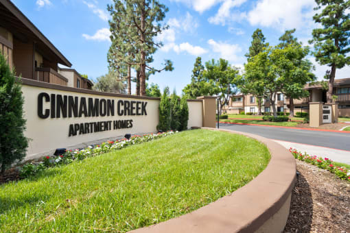 the sign homes in front of a grassy