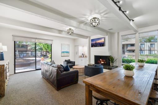 a living room with couches and a table and a fireplace