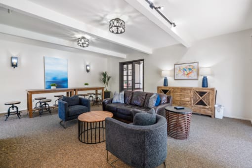 a living room with couches and chairs and a desk