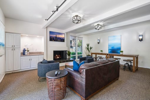 a living room with a leather couch and a fireplace