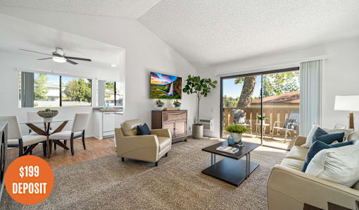 A living room with a couch, chairs, and a coffee table.