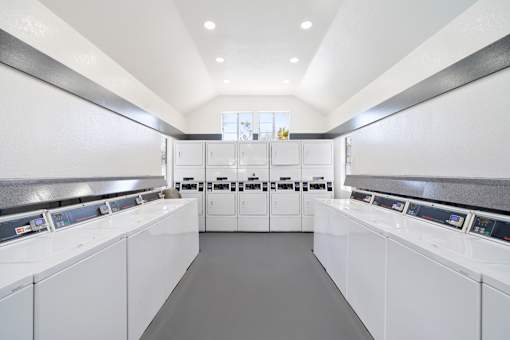 A laundromat with rows of washers and dryers.