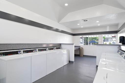 A laundromat with rows of washers and dryers.