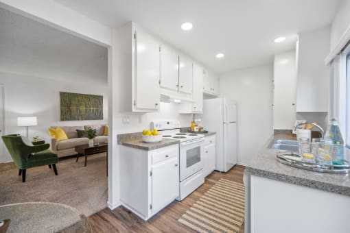a white kitchen with white appliances and white cabinets