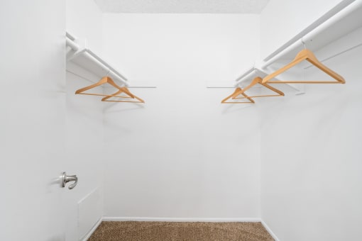 a white room with two hanging racks on the wall