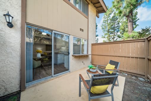 a patio with two chairs and a table on it