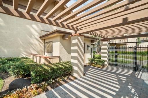 a patio with awnings and a staircase in front of a building