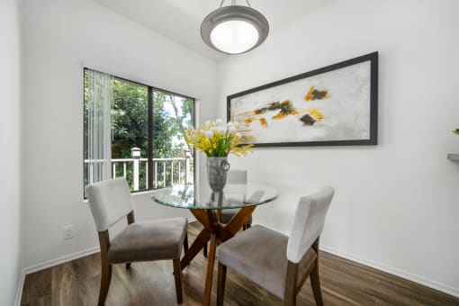 a dining room with a glass table and chairs