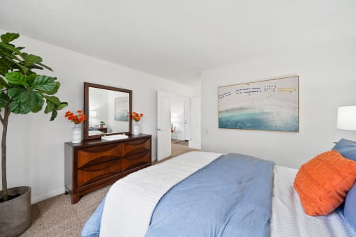 a bedroom with a bed and a dresser