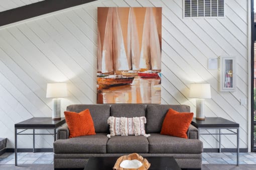 a living room with a couch and a painting on the wall
