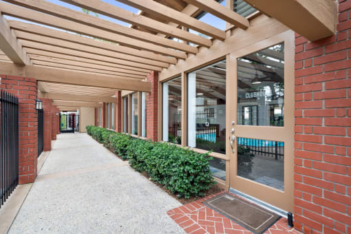 the entrance to a building with a walkway and awning