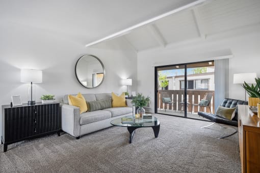 a living room with a couch and a glass coffee table