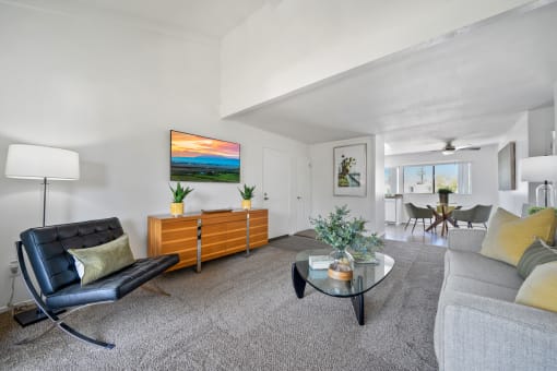 a living room with a couch and a glass coffee table