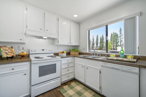 a white kitchen with white appliances and white cabinets