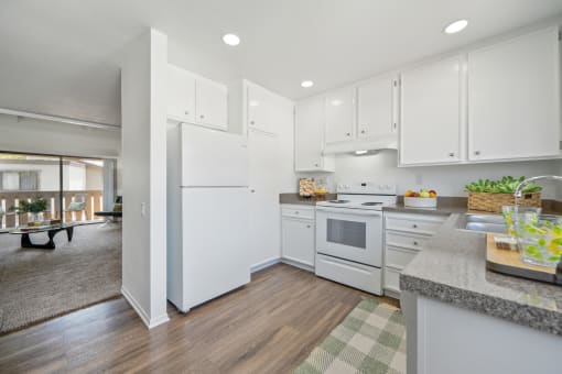 a renovated kitchen with white appliances and white cabinets
