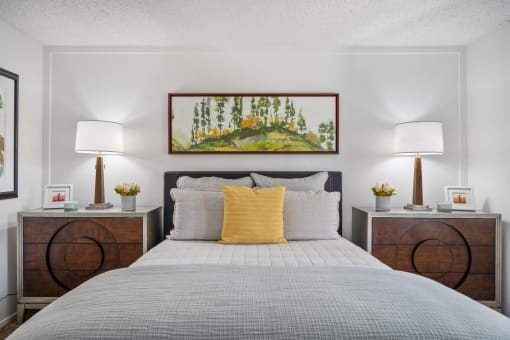 a bedroom with a bed and two night stands with lamps
